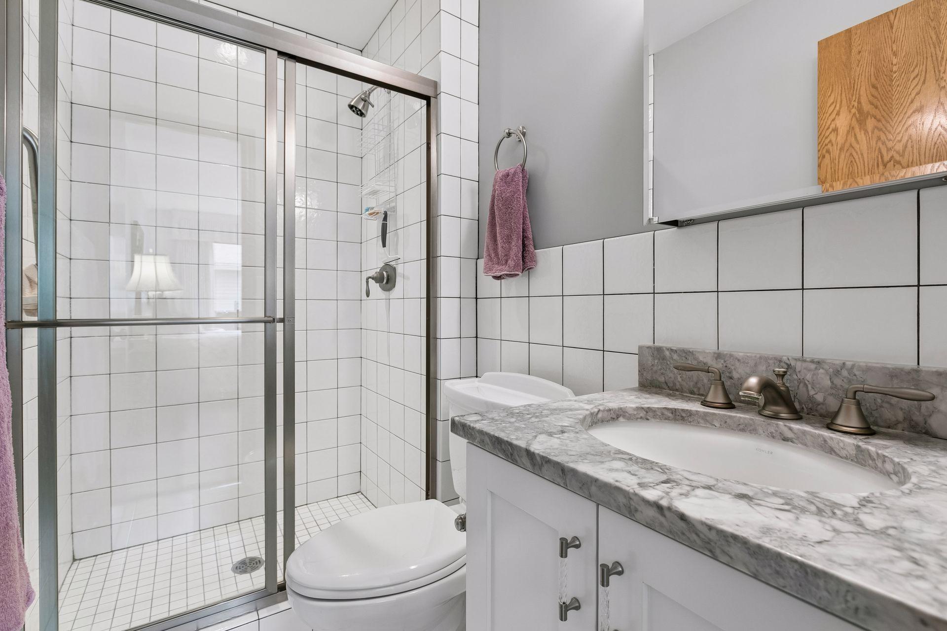 3/4 Updated Primary Bath with Quartz vanity top.