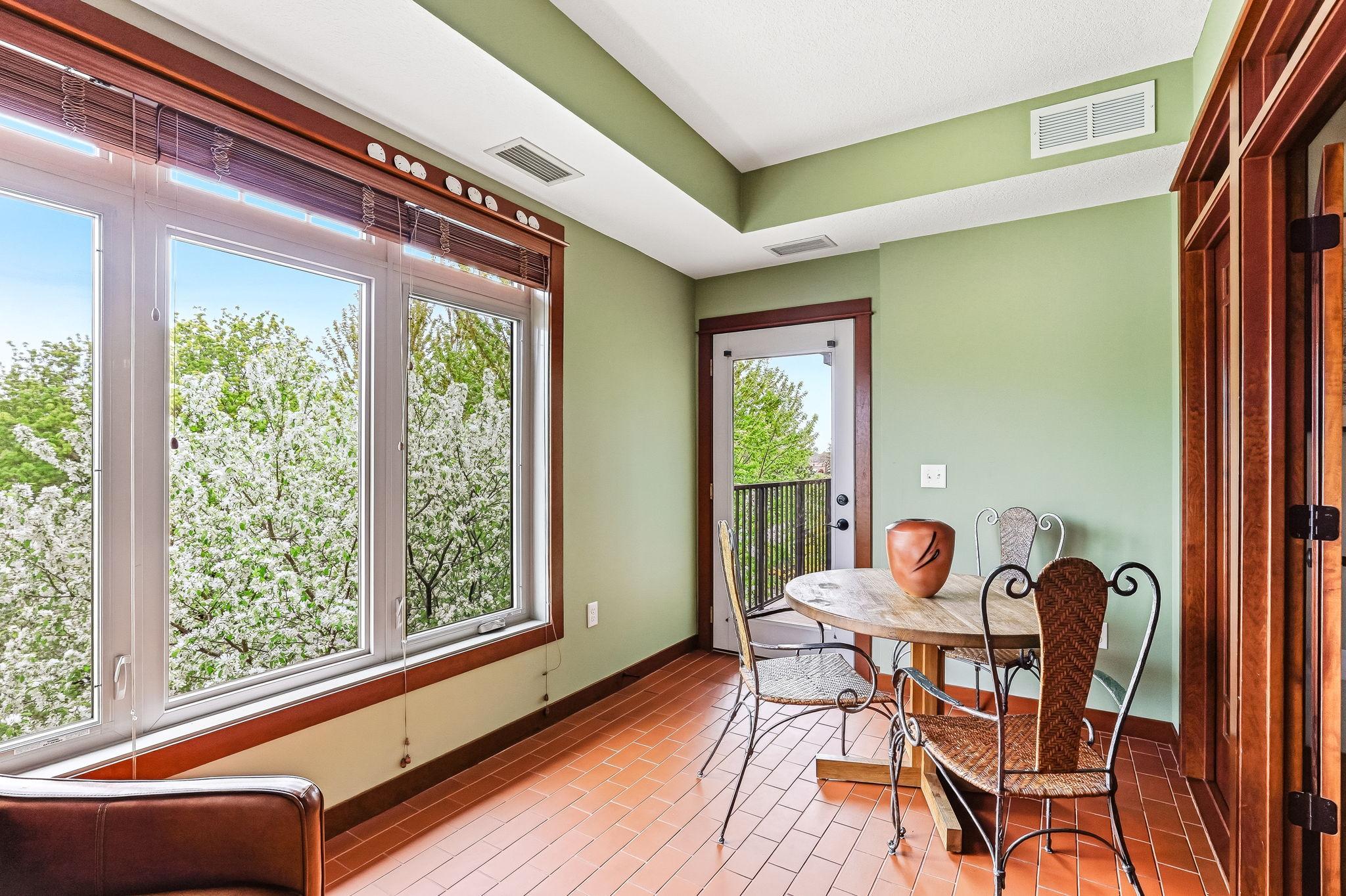 Light filled 4 season sunroom with door to deck.