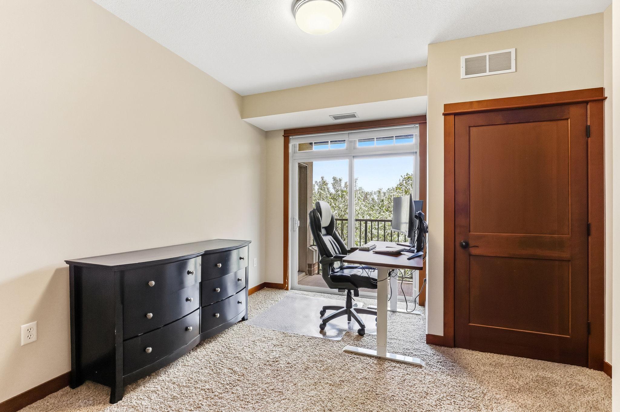 Spacious light filled 2nd bedroom with access to deck.