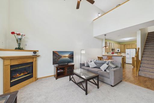 Bright and spacious open floor plan with stunning high ceilings and a gas fireplace for added charm.