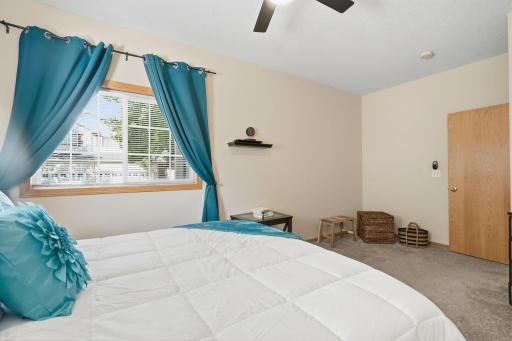 Lighted ceiling fan and 2 big windows add to the ambiance of the room.