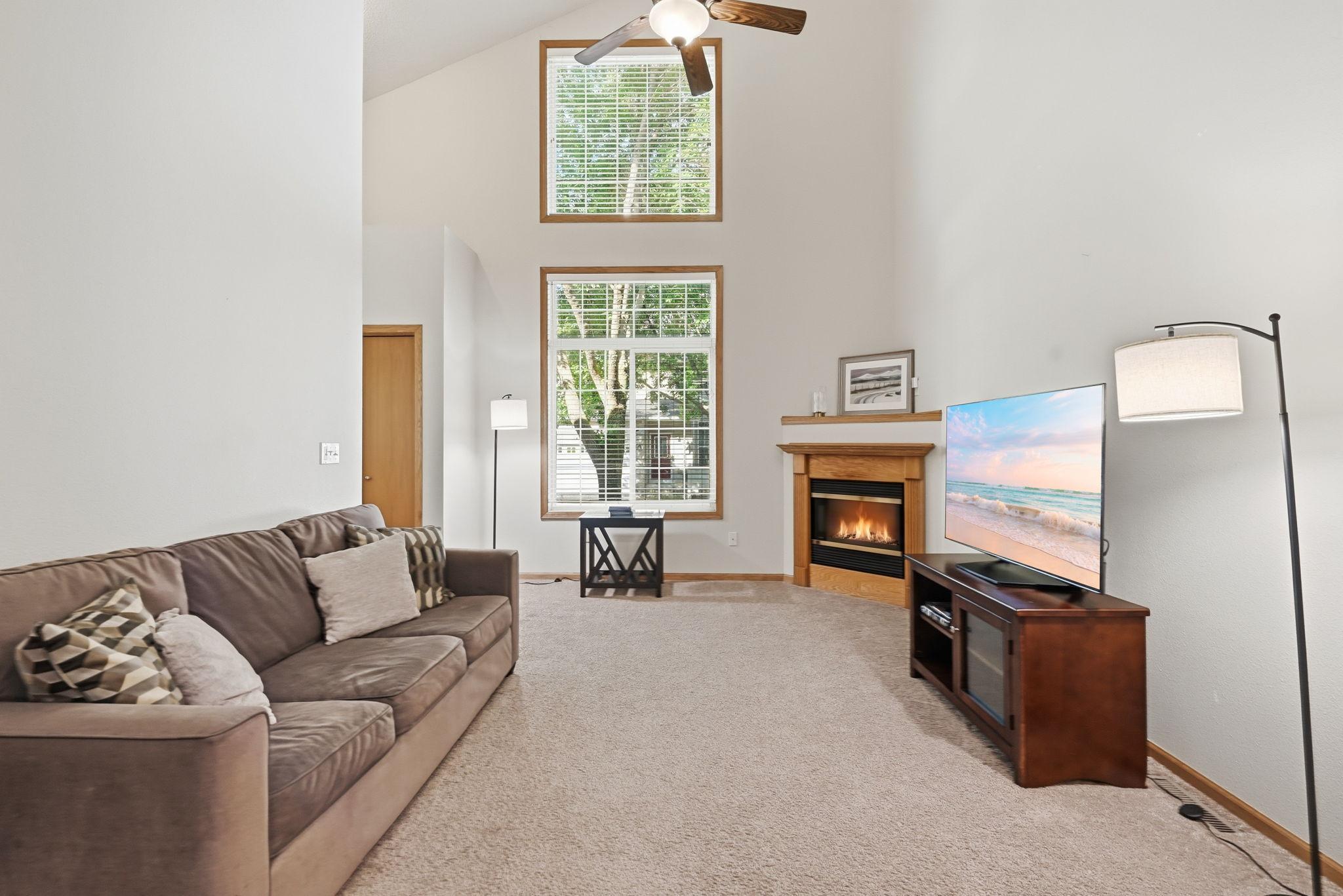 Photo for 11457 16th Street NE, Saint Michael, MN 55376 - Listing #7071995 An impressive vaulted ceiling and stacked windows fill the spacious living room with natural light.