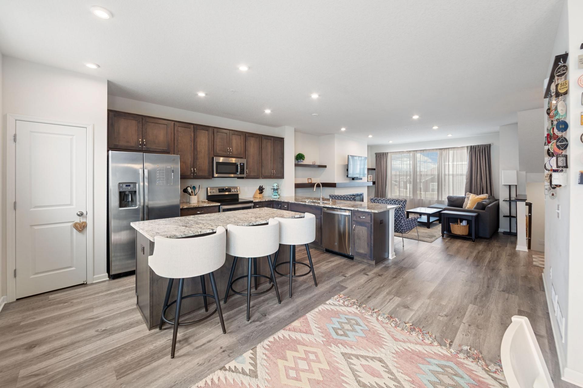 Large open floor plan with 9 foot ceilings, birch cabinets, granite countertops, stainless steel appliance and eat-in center island and pantry.