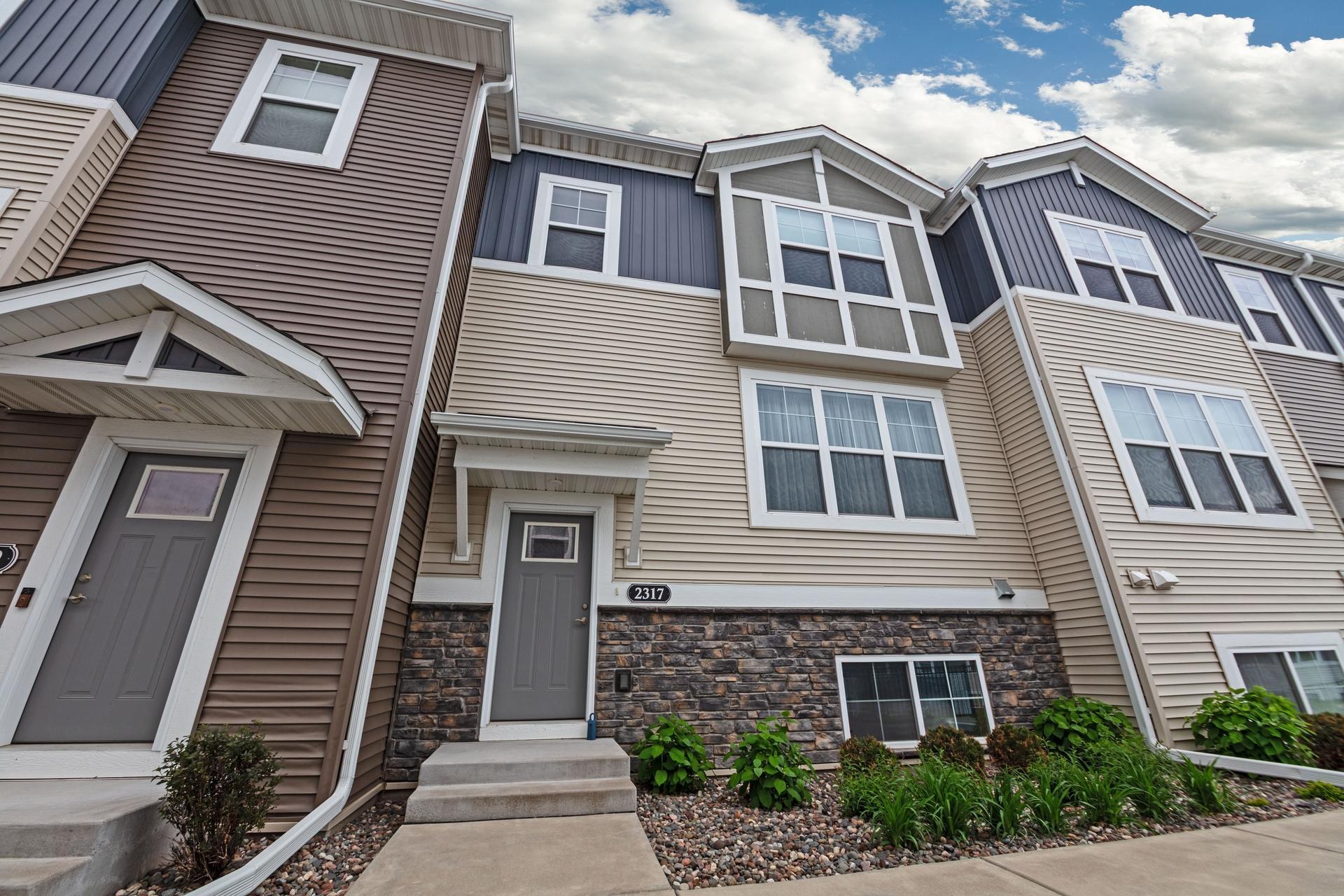 Front door of home with sidewalk area.