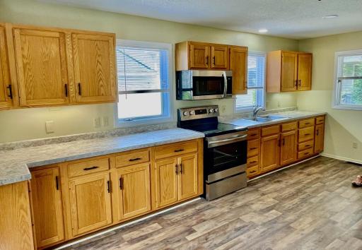 Oak cabinets with updated hardware, lots of windows for natural light
