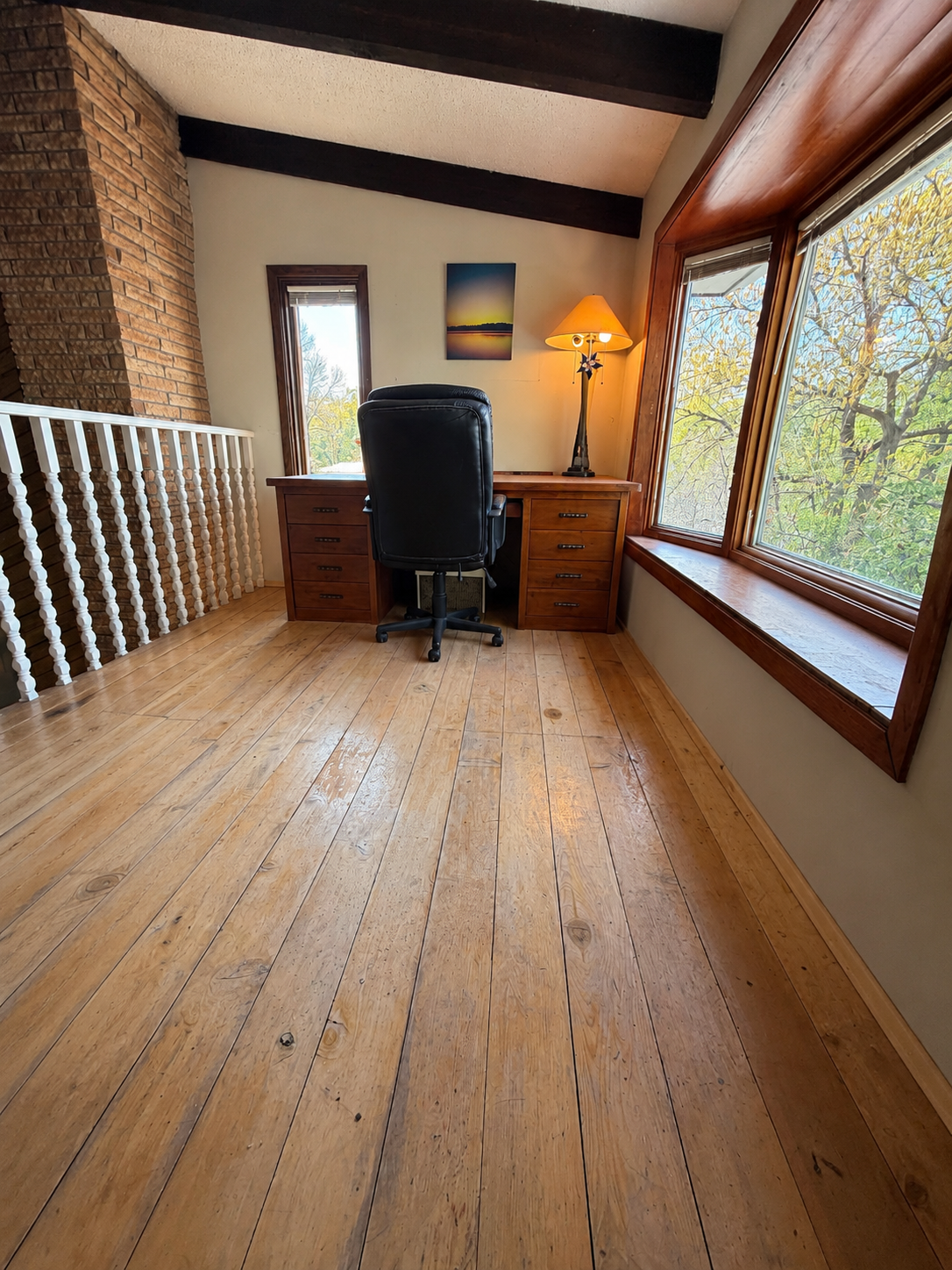 Main floor office overlooks family room. Photo is AI Enhanced.