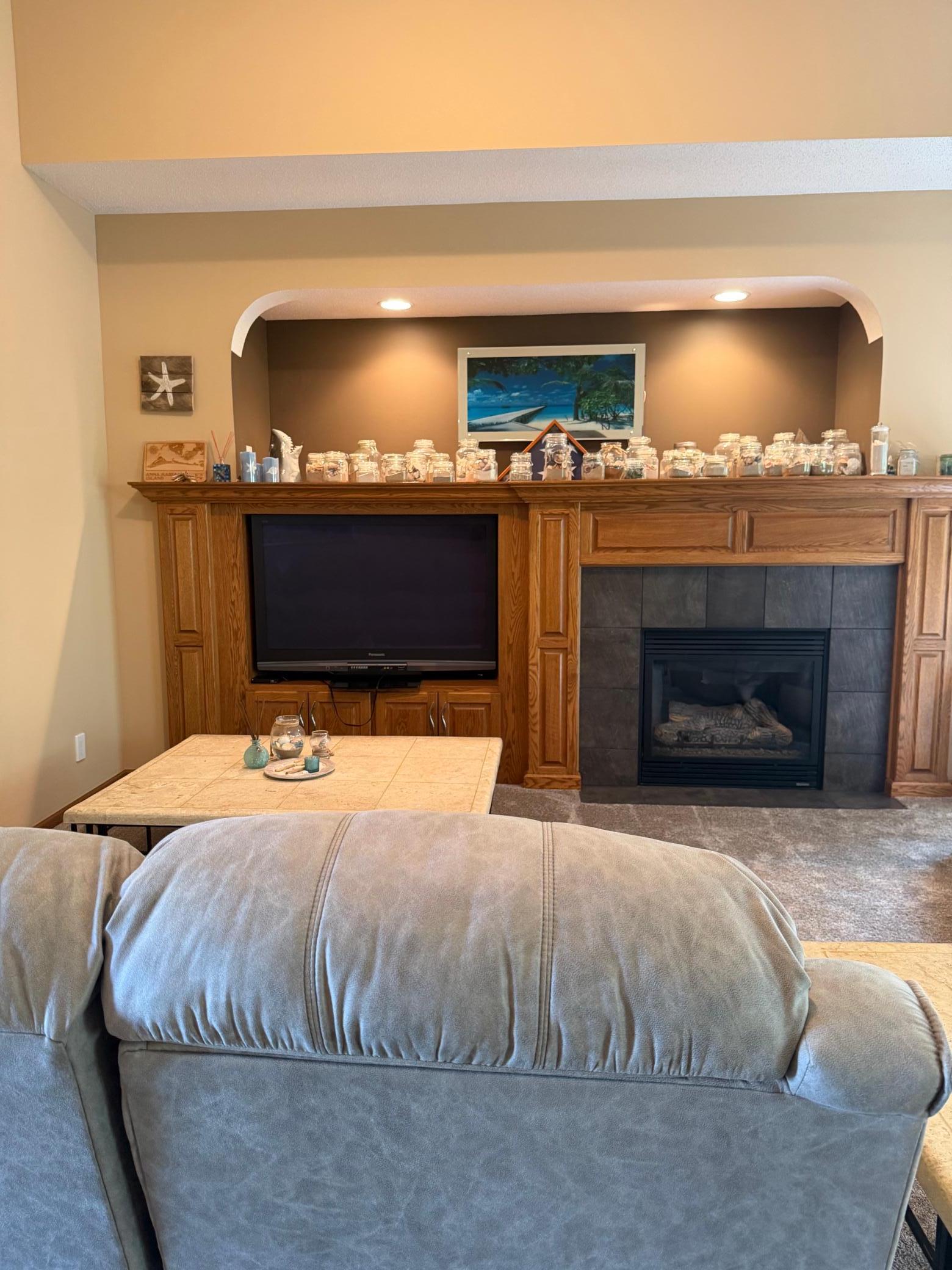 Large open livng room complete with fire place and built in entertainment center.