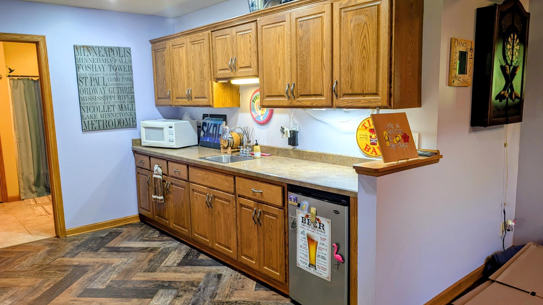 Lower level has a wet bar complete with a mini fridge for pop or... "beer".