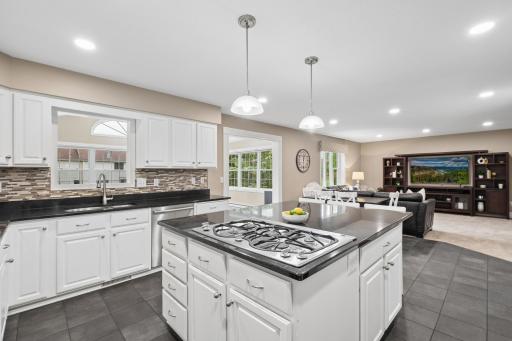 This kitchen is thoughtfully positioned to offer definition between spaces while maintaining an easy flow to the sunroom, living room, and main floor office.