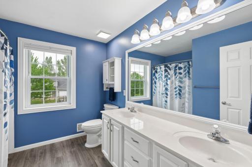 Spacious upper level updated bathroom with dual sinks and tub/shower. This spacious bathroom offers ample countertop space and room to get ready comfortably.