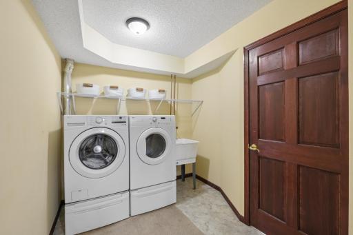 This spacious laundry room offers more room than it appears, with space for a freezer, storage, and everyday functionality. Also complete with a utility sink and access to the mechanical room.