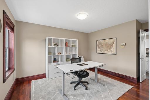 The main floor office is ideally positioned at the front of the home, offering a quiet and functional workspace. Hardwood floors add style, while the location provides convenient flow between the entry and kitchen.