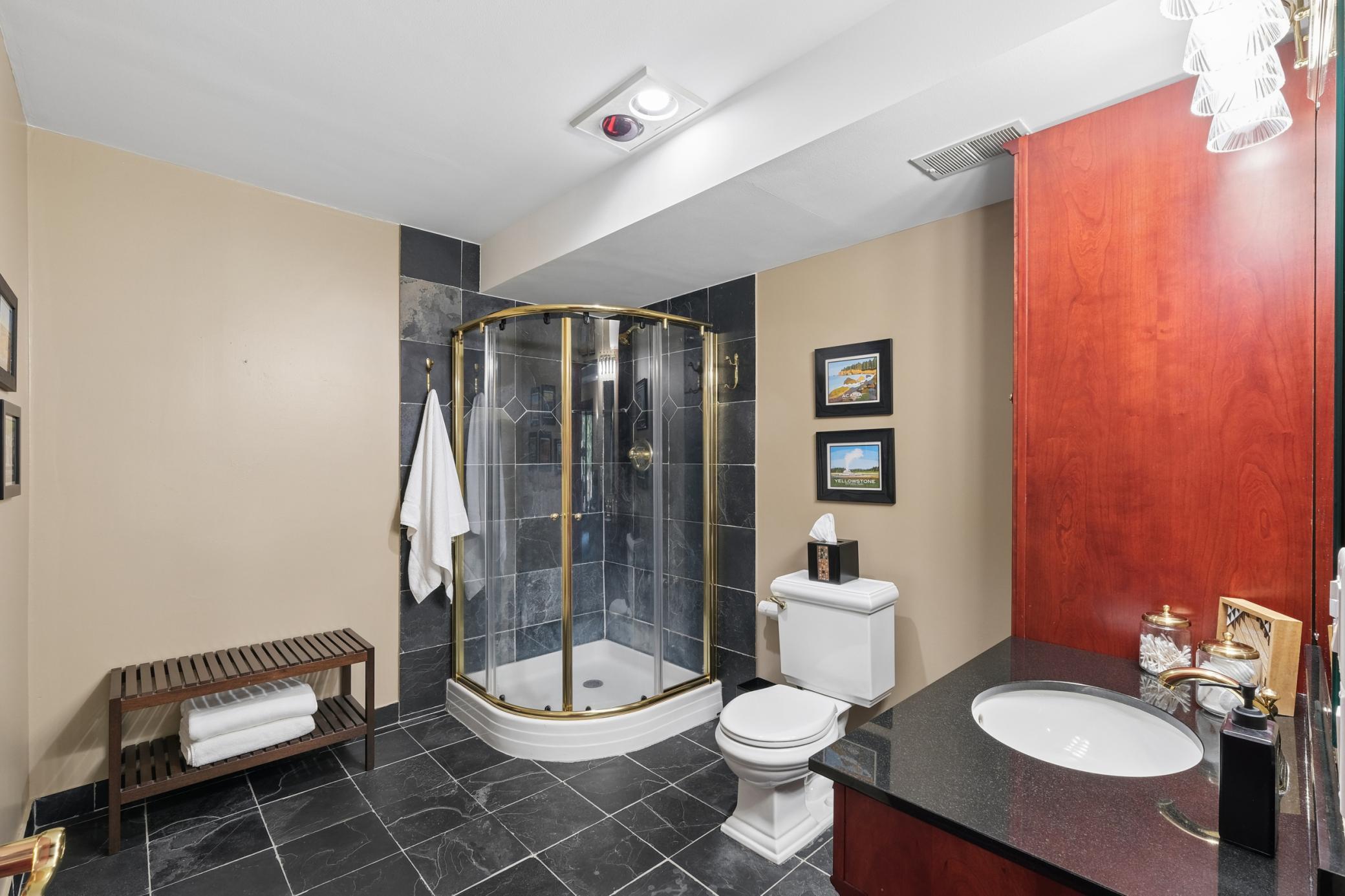 Lower level bathroom retreat. This spa-inspired bathroom features elegant tile floors that stay cool and refreshing underfoot, creating the perfect transition after an evening soak in the outdoor hot tub.