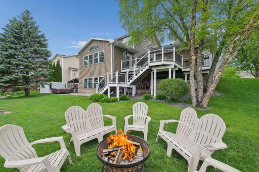 Level backyard perfect for games, entertaining, and outdoor gatherings, complete with a firepit and peaceful water views.