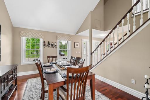Formal dining room with hardwood floors and plenty of space for entertaining guests. The classic layout offers a clean, functional space with warm wood finishes and a comfortable flow into the surrounding living areas.