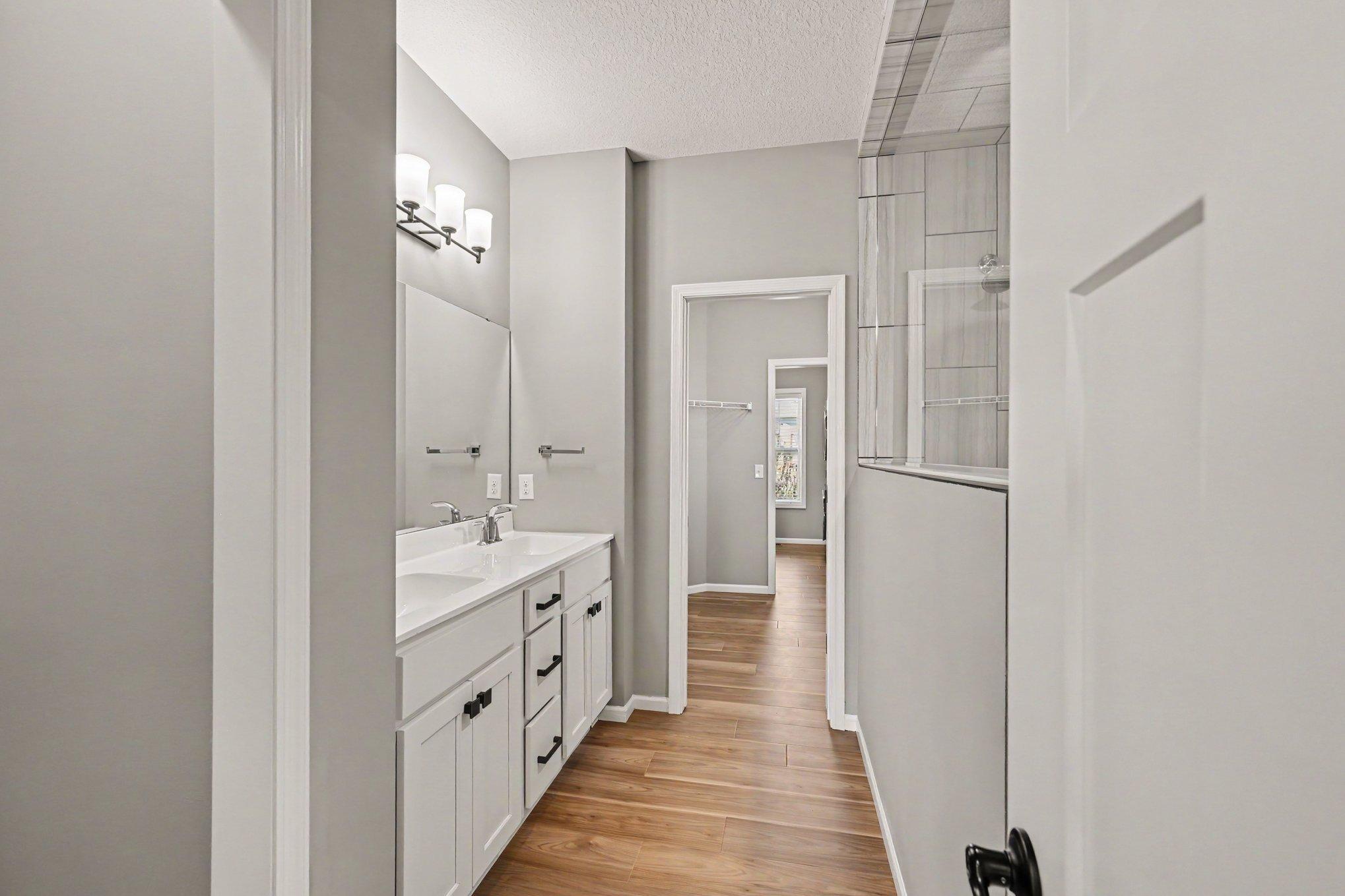 Walk-through primary bathroom connects to the large closet