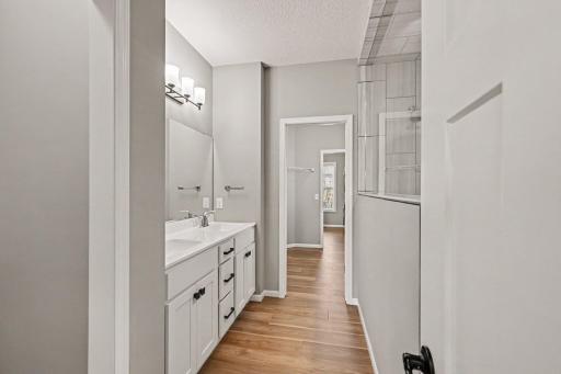 Walk-through primary bathroom connects to the large closet