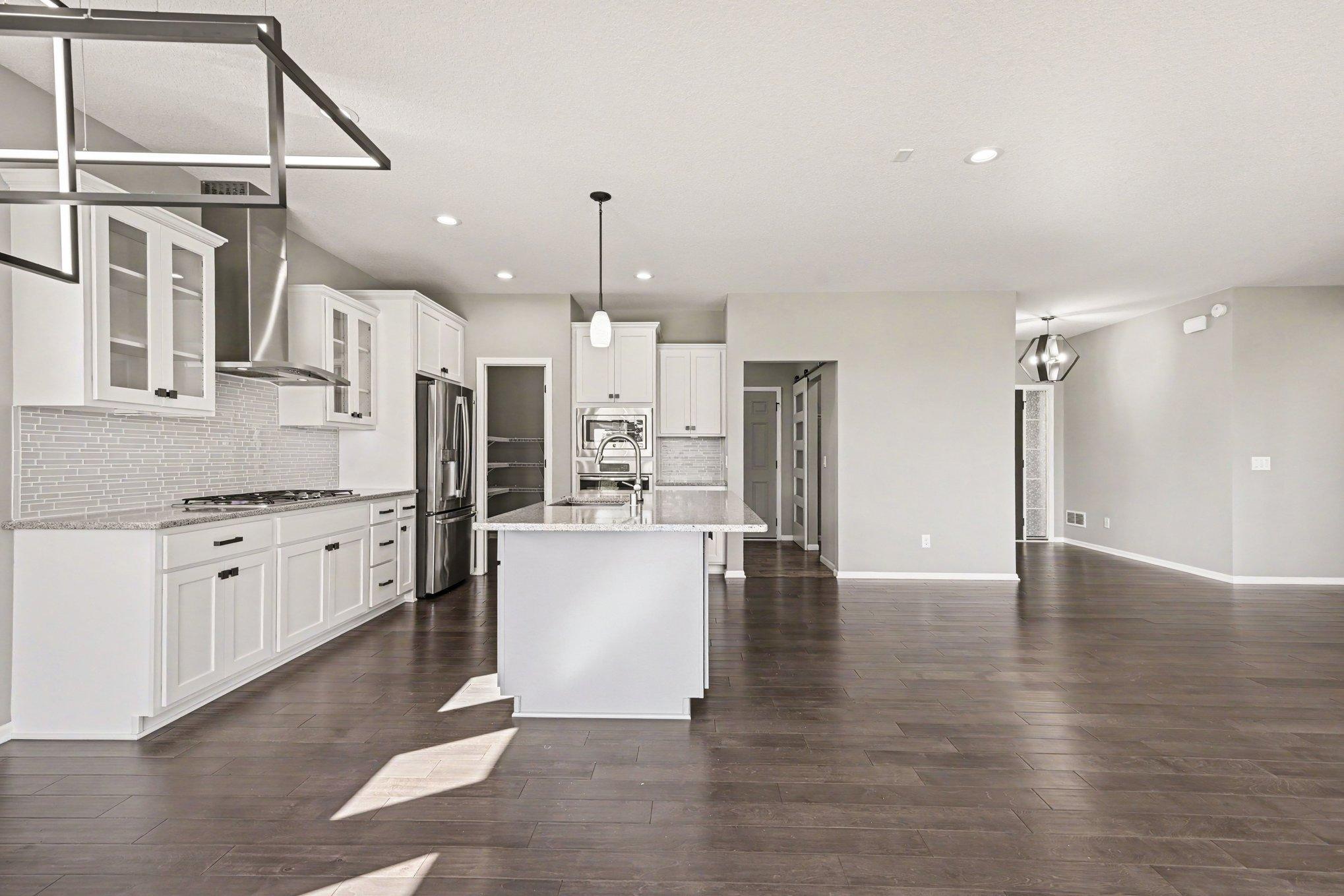 Kitchen features a walk-in pantry and connects to the mudroom