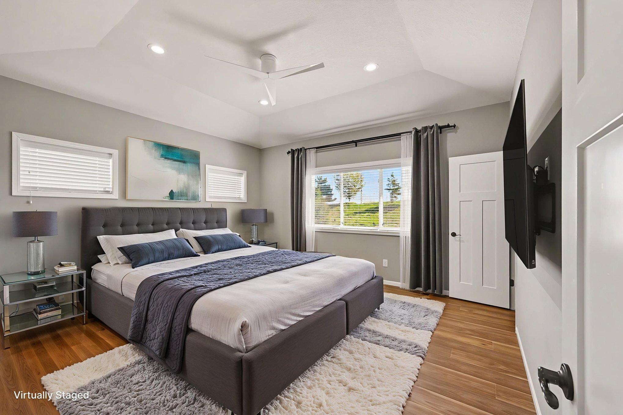 Virtually staged main level primary bedroom