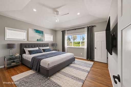 Virtually staged main level primary bedroom.png