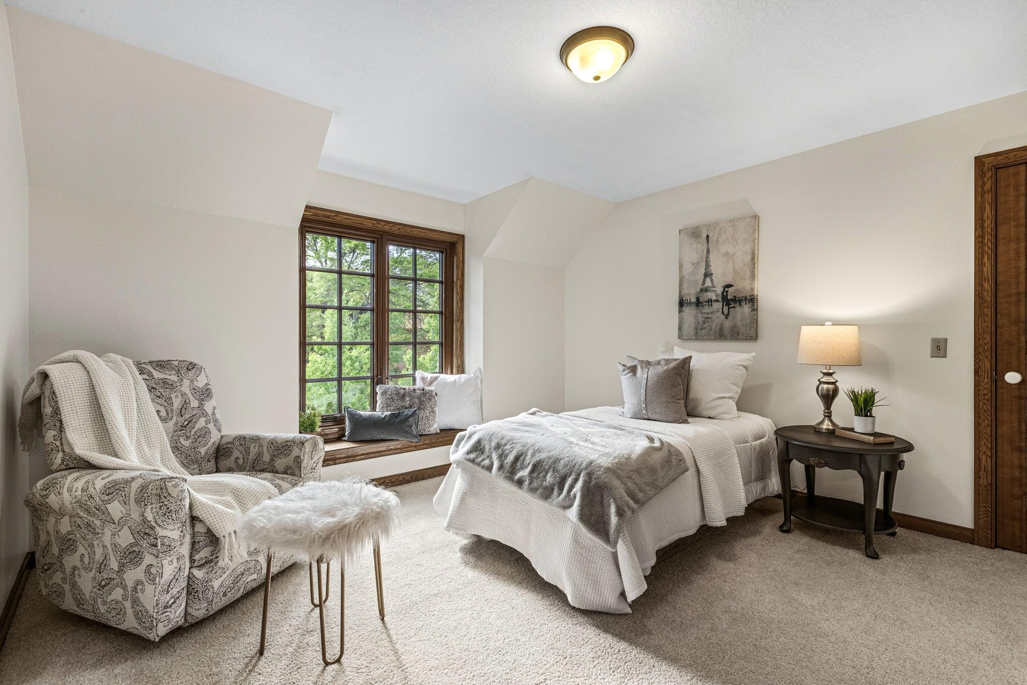 3rd bedroom on upper level with walk-in closet and cozy window seat.