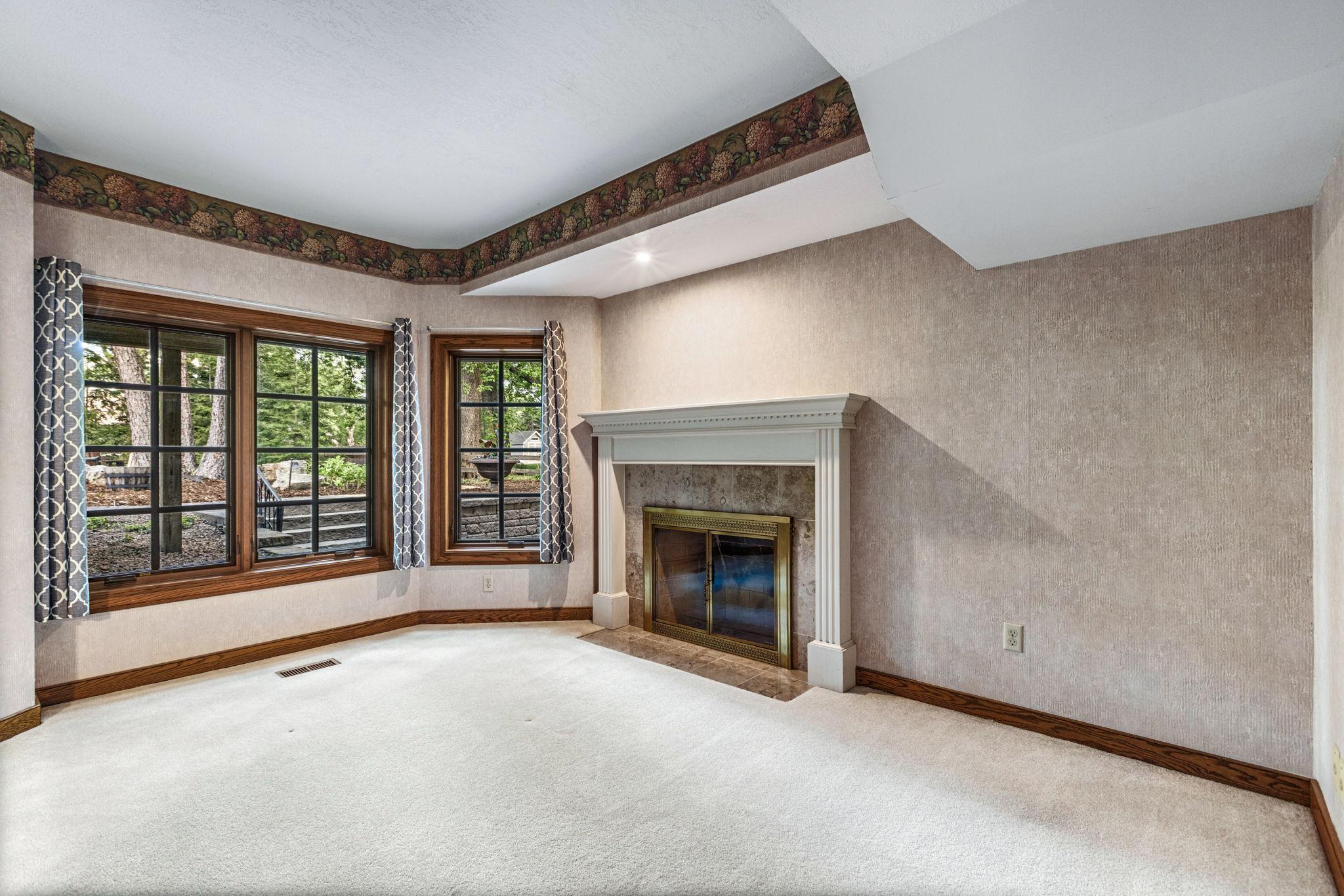 5th bedroom in lower level with incredible views of the backyard.