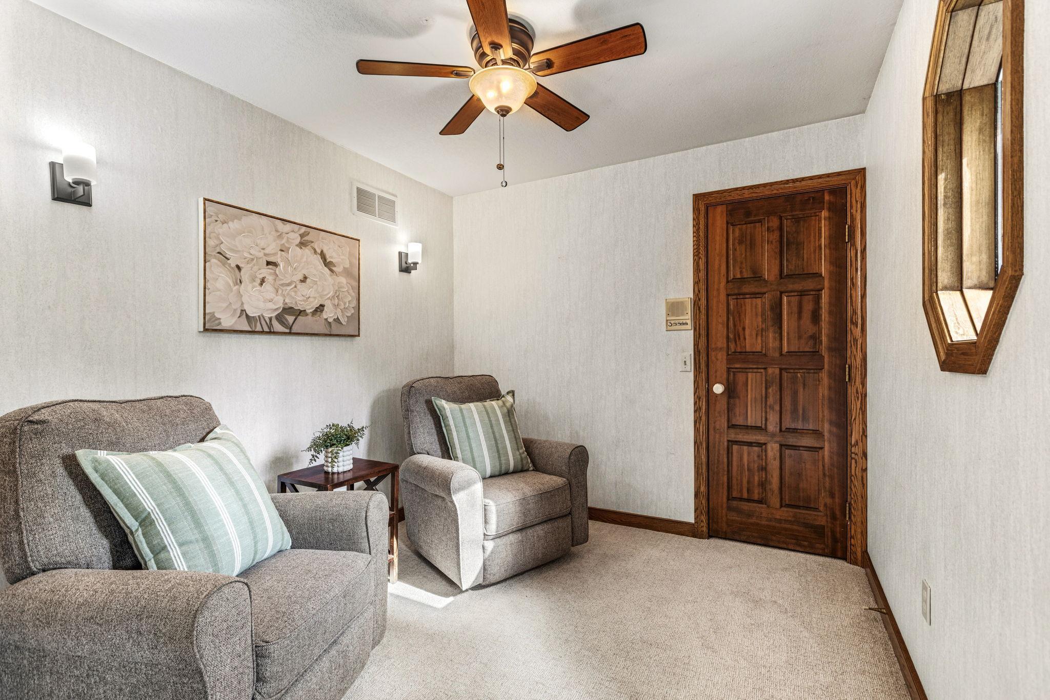 Reading area in 4th bedroom with ceiling fan and walk-in closet.