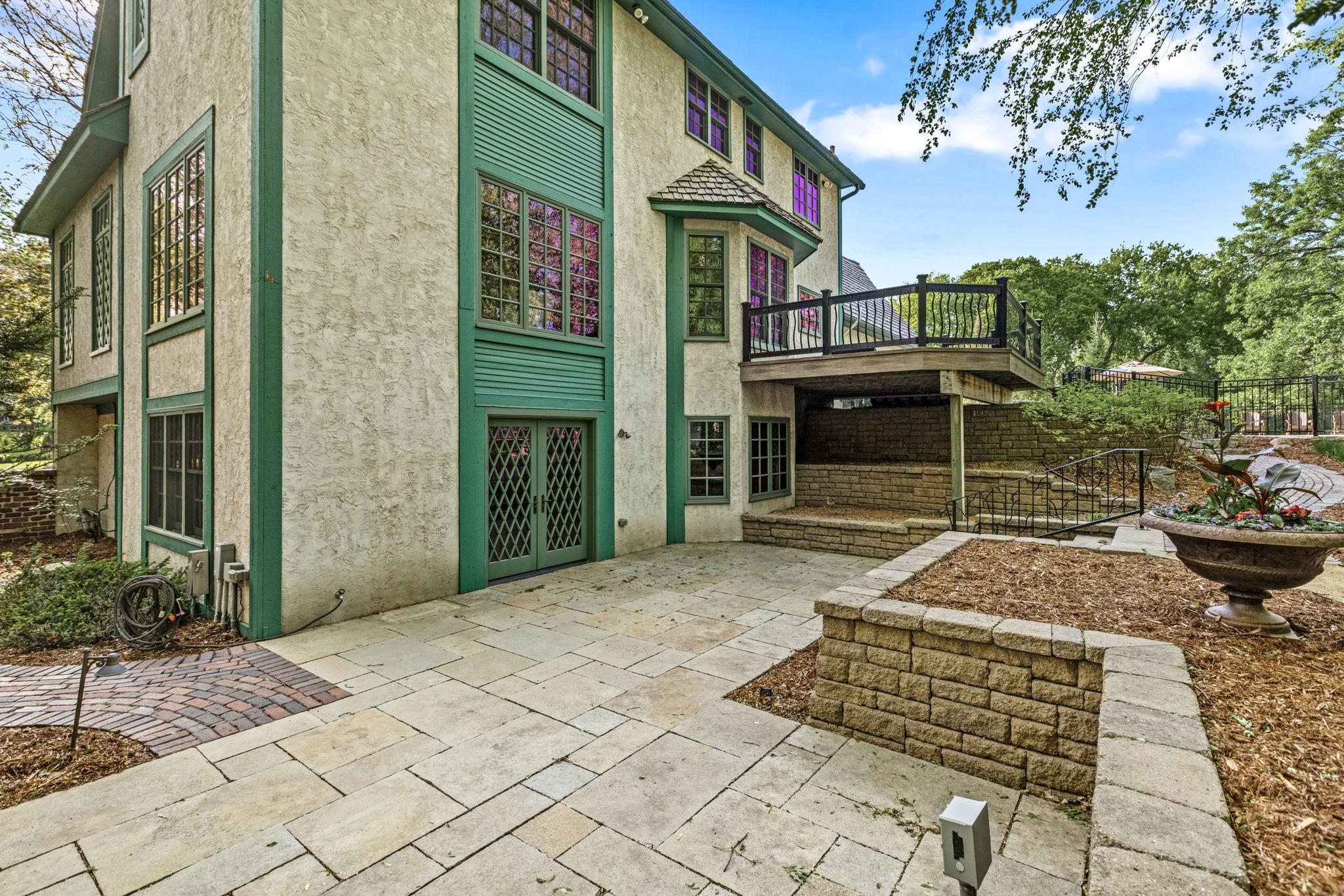 Expansive lower-level patio and upper deck create exceptional outdoor living spaces.