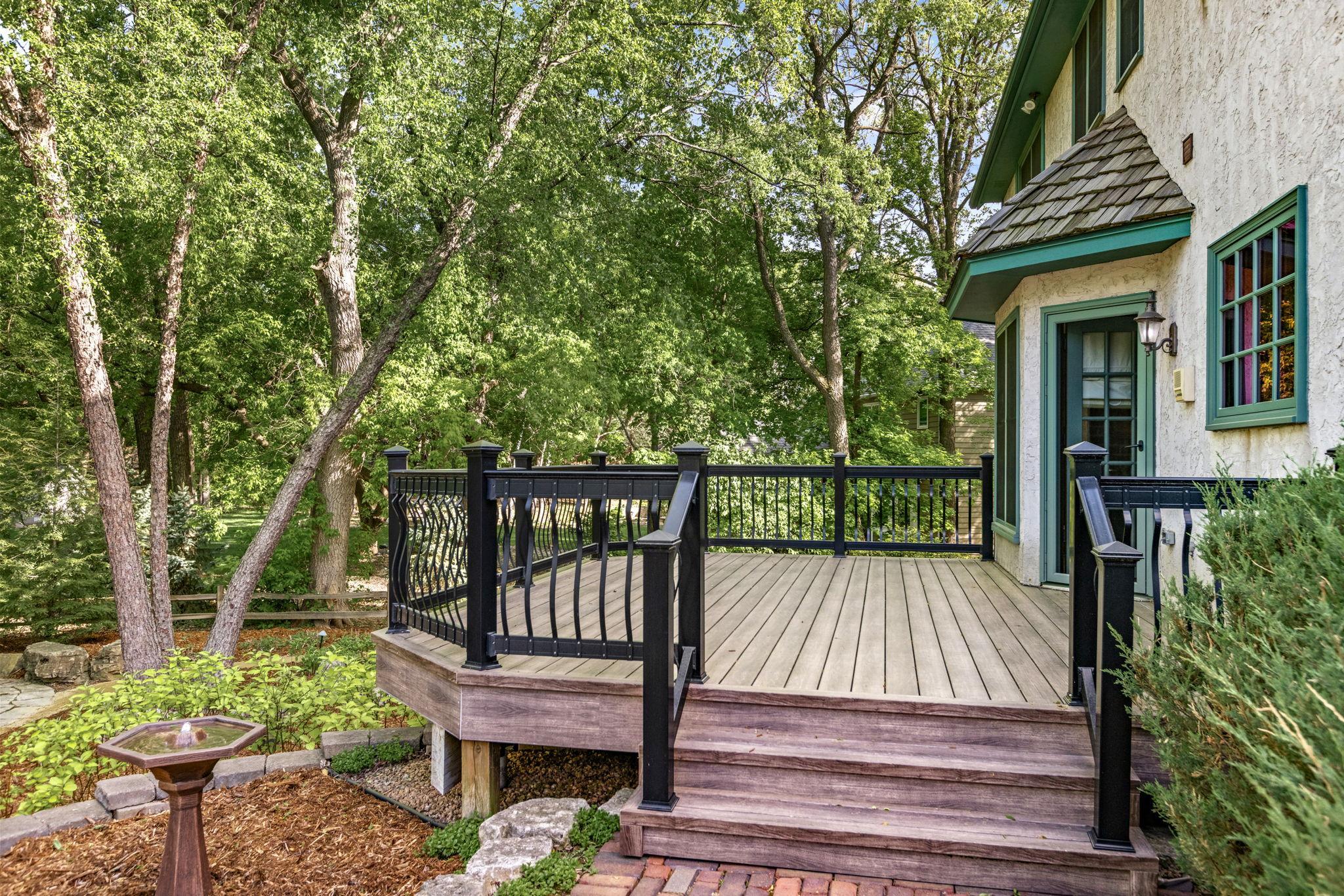Maintenance-free deck overlooking mature trees and lush landscaping — the perfect setting for morning coffee, outdoor dining or relaxing evenings surrounded by nature.