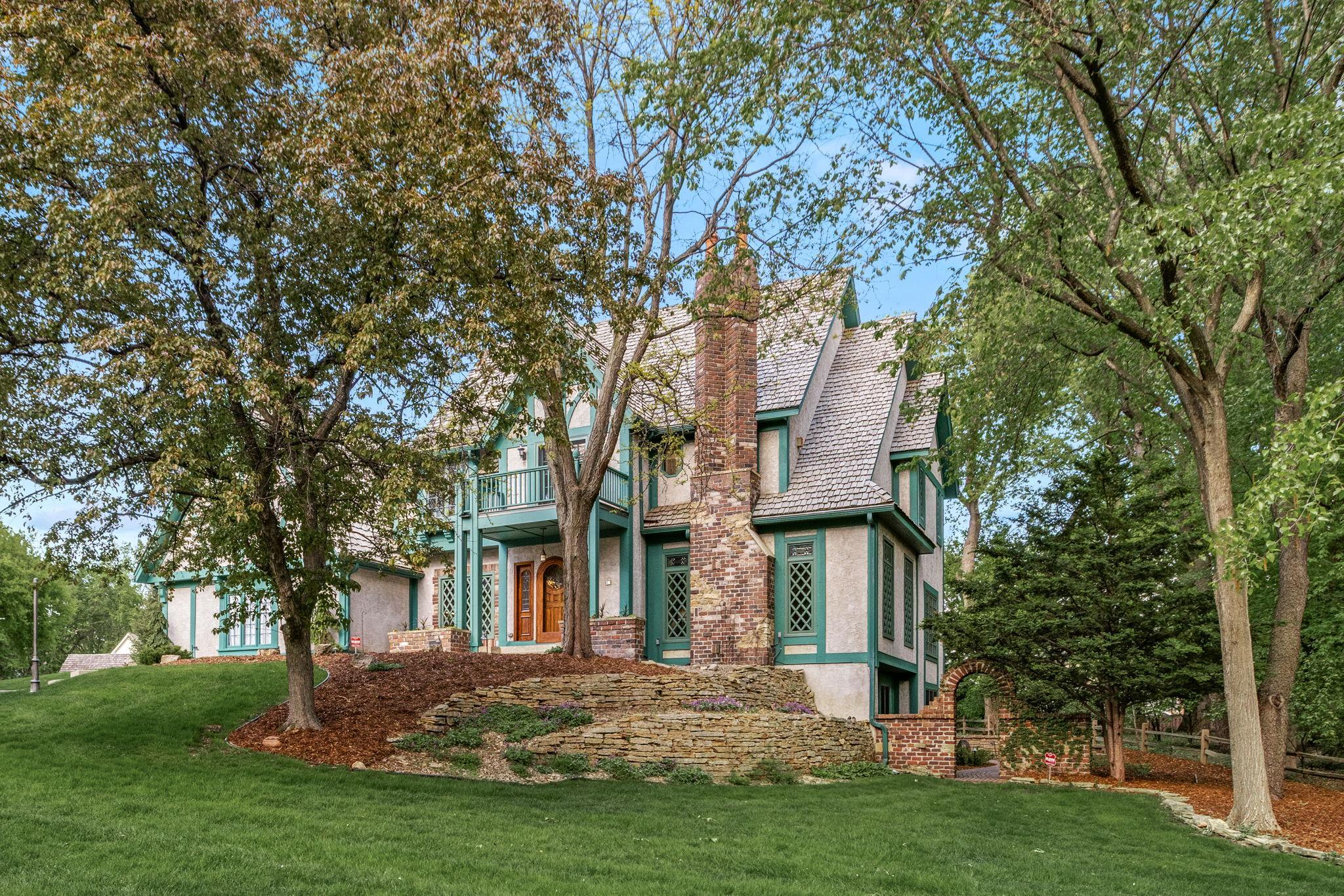 Nestled among mature trees and lush landscaping, this home offers storybook charm and exceptional curb appeal.