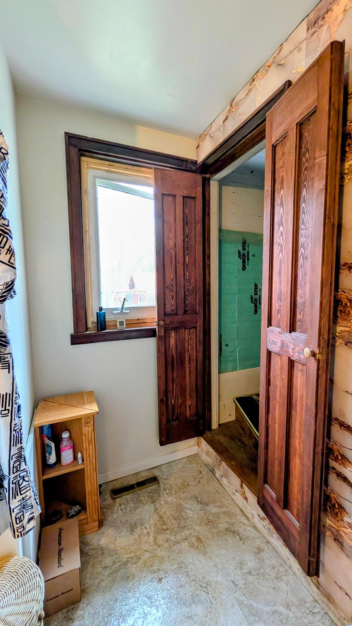 Stairs in bathroom lead to upper level