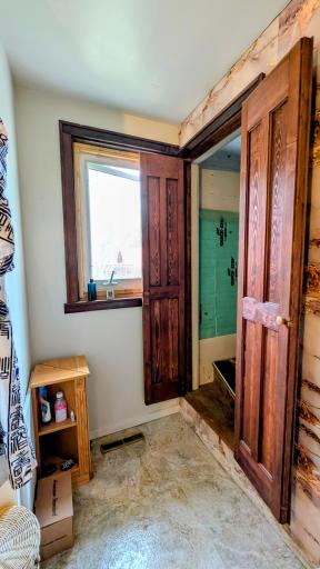 Stairs in bathroom lead to upper level