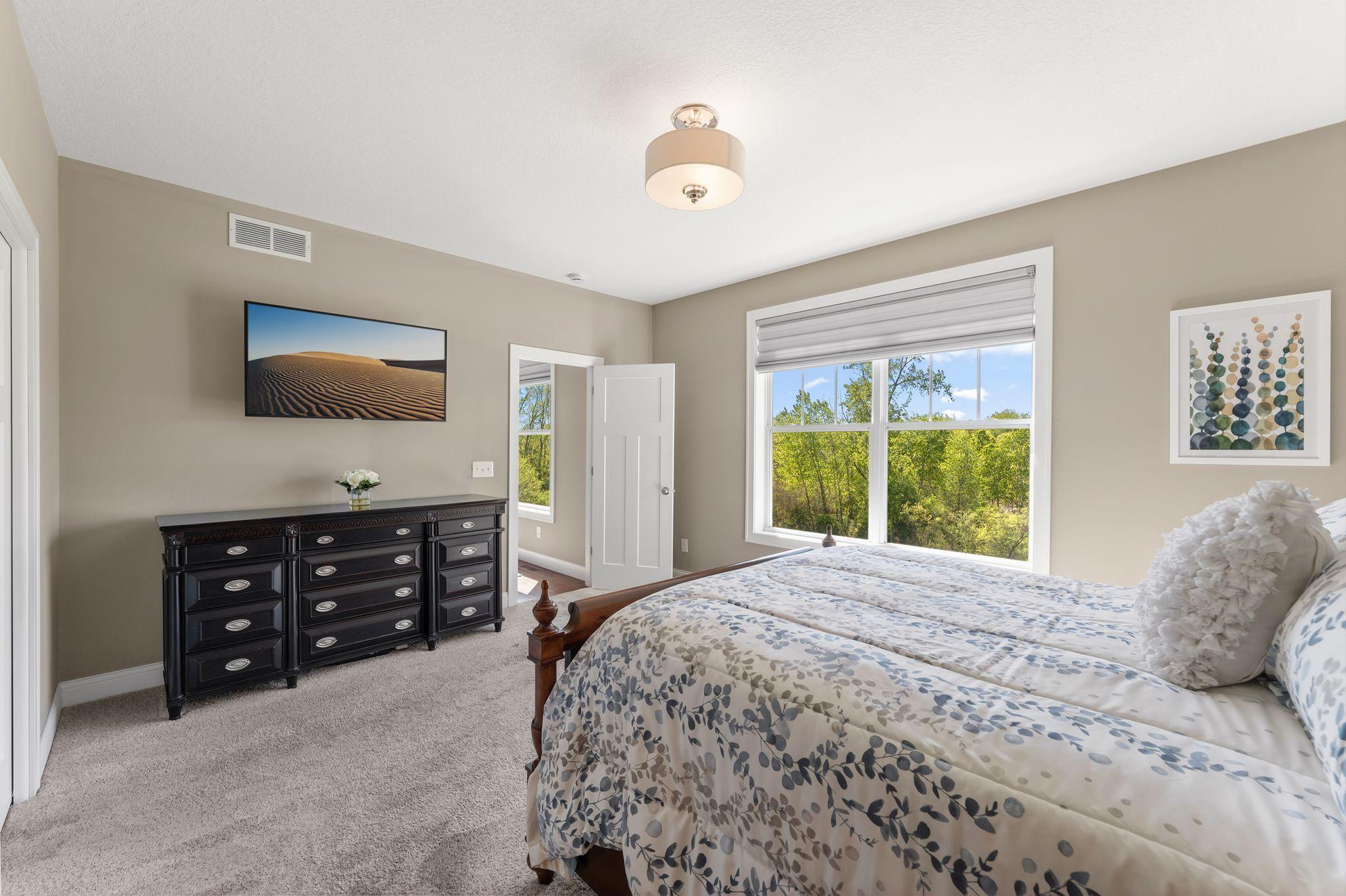 Primary bedroom has custom window treatments
