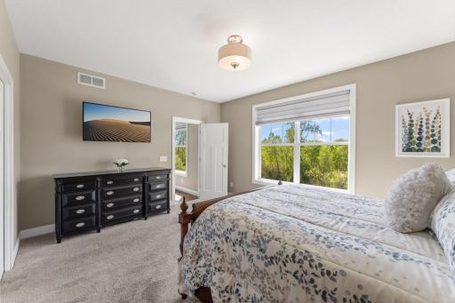 Primary bedroom has custom window treatments