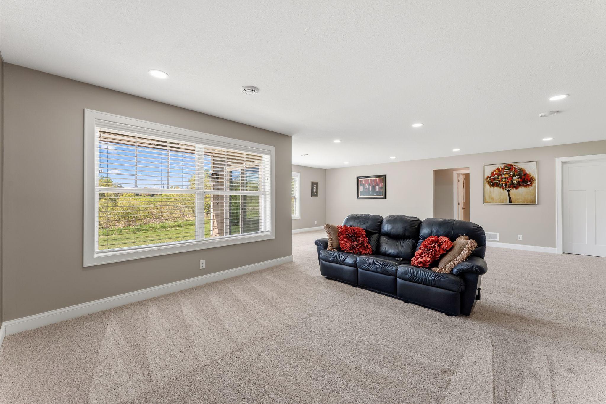 Lower level has large windows and a patio door for great views