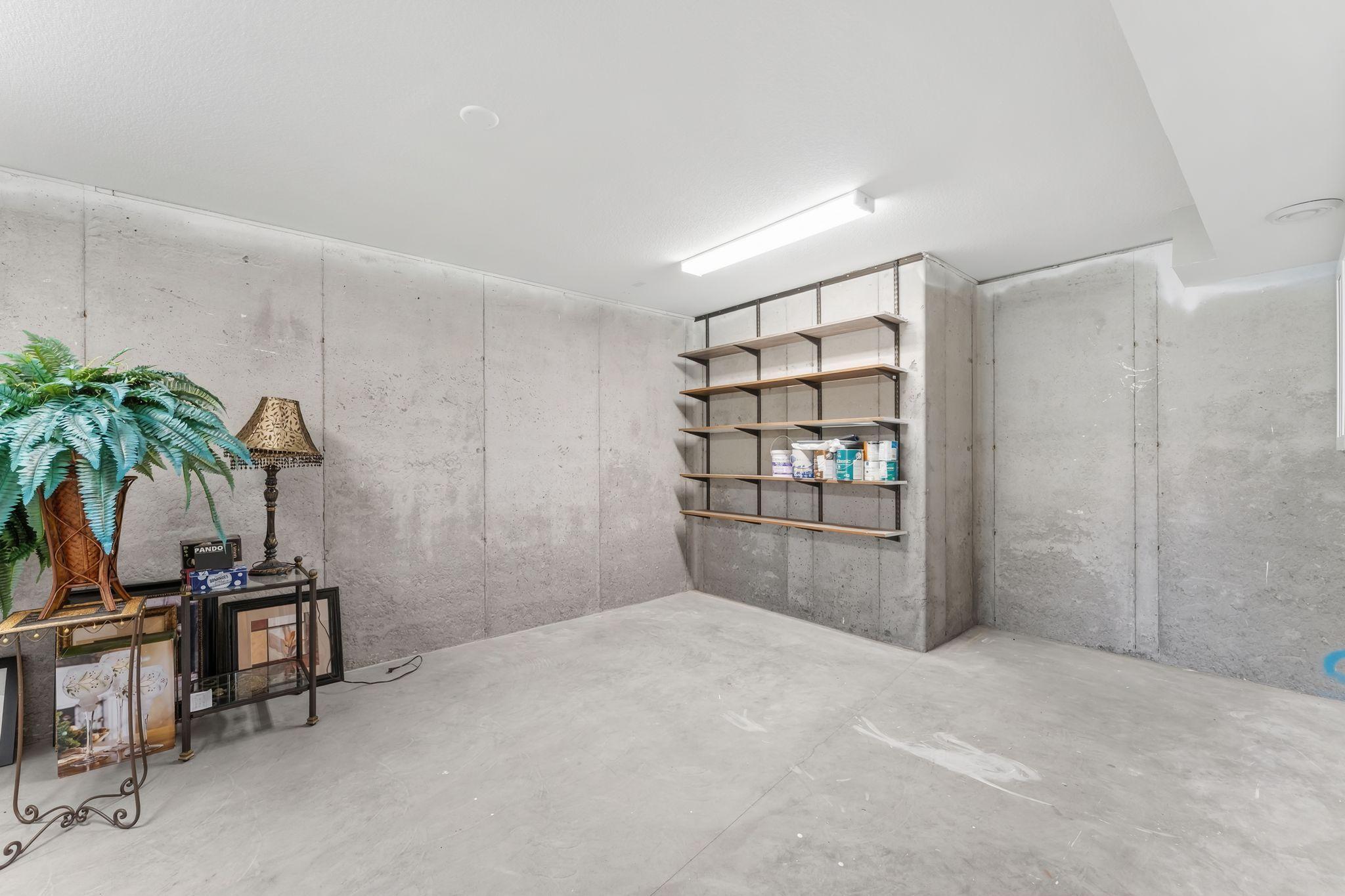 Lower level shop area with shelving and cabinets