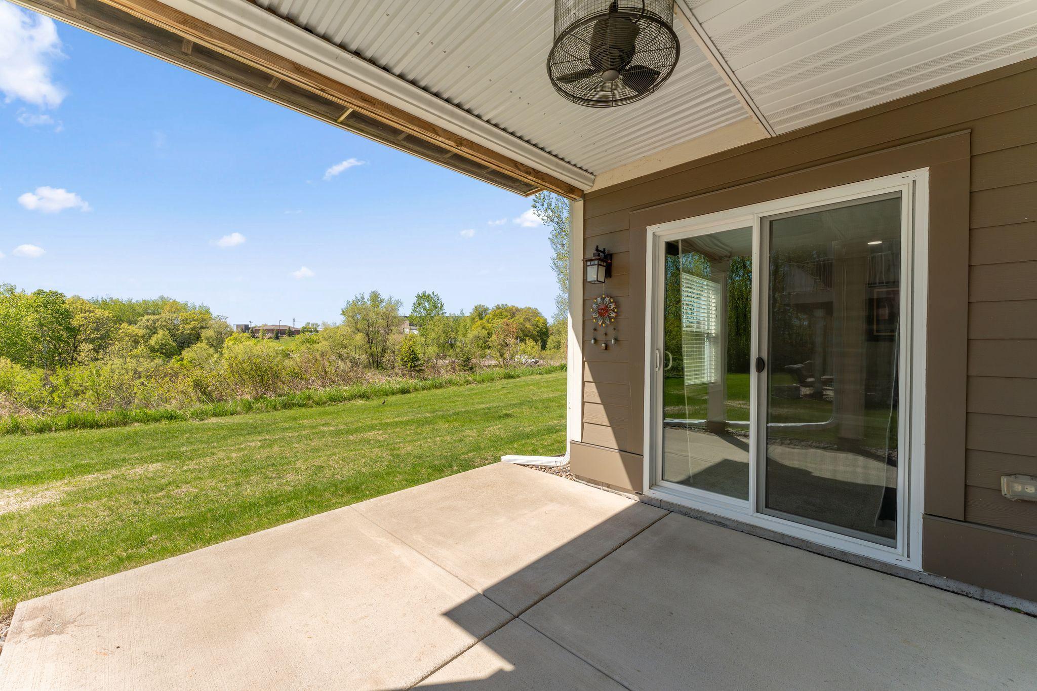 Covered patio has fan and sun shade
