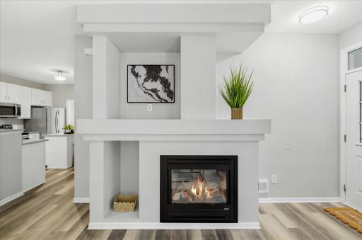 The striking fireplace serves as the heart of the home, adding warmth, style, and the perfect focal point for cozy evenings or gathering with guests.