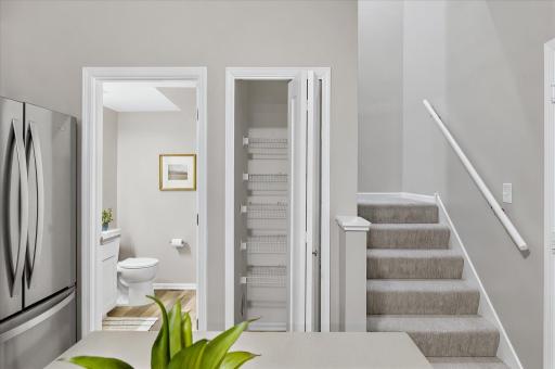 Convenience continues on the main level with an updated half bath and practical storage, making daily living both comfortable and efficient.