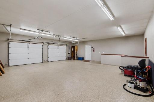 Main floor 30 x 32 garage- side access door to main floor hallway, and stairway to lower level garage