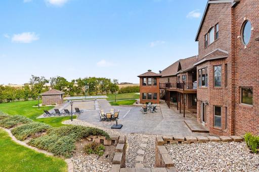 Beautiful backyard includes basketball/pickleball court, inground pool-pool house, stamped concrete patio with firepit, screened in sunroom & lower level has hot tub.