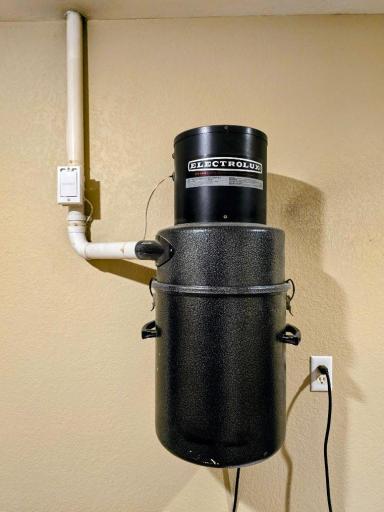 Central vac is located in storeroom located next to garage.