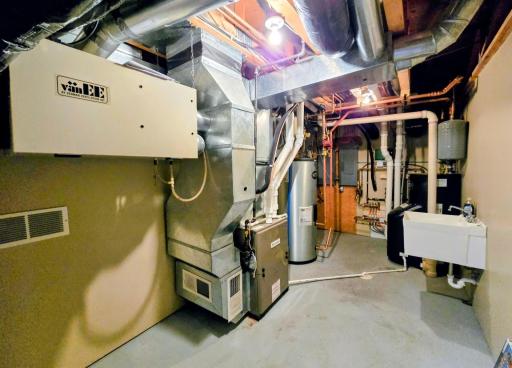 Utility room #1-air exchange unit, forced air furnace, new stainless steel waterheater, utility sink, newer boiler, 2-200 amp breaker boxes