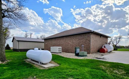 Behind 30 x 50 garage-propane tank, generator,