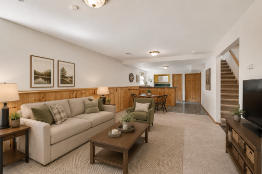 Spacious lower-level walkout living area offering the perfect setup for entertaining, game nights, movie watching, or hosting family and friends year-round.