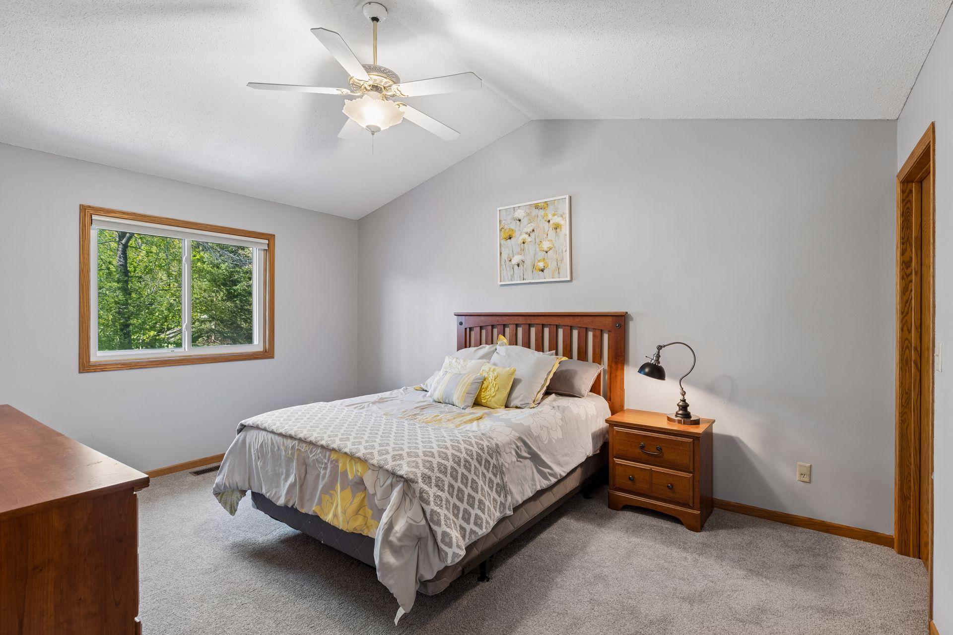 Primary bedroom with new carpet and vaulted ceilings.