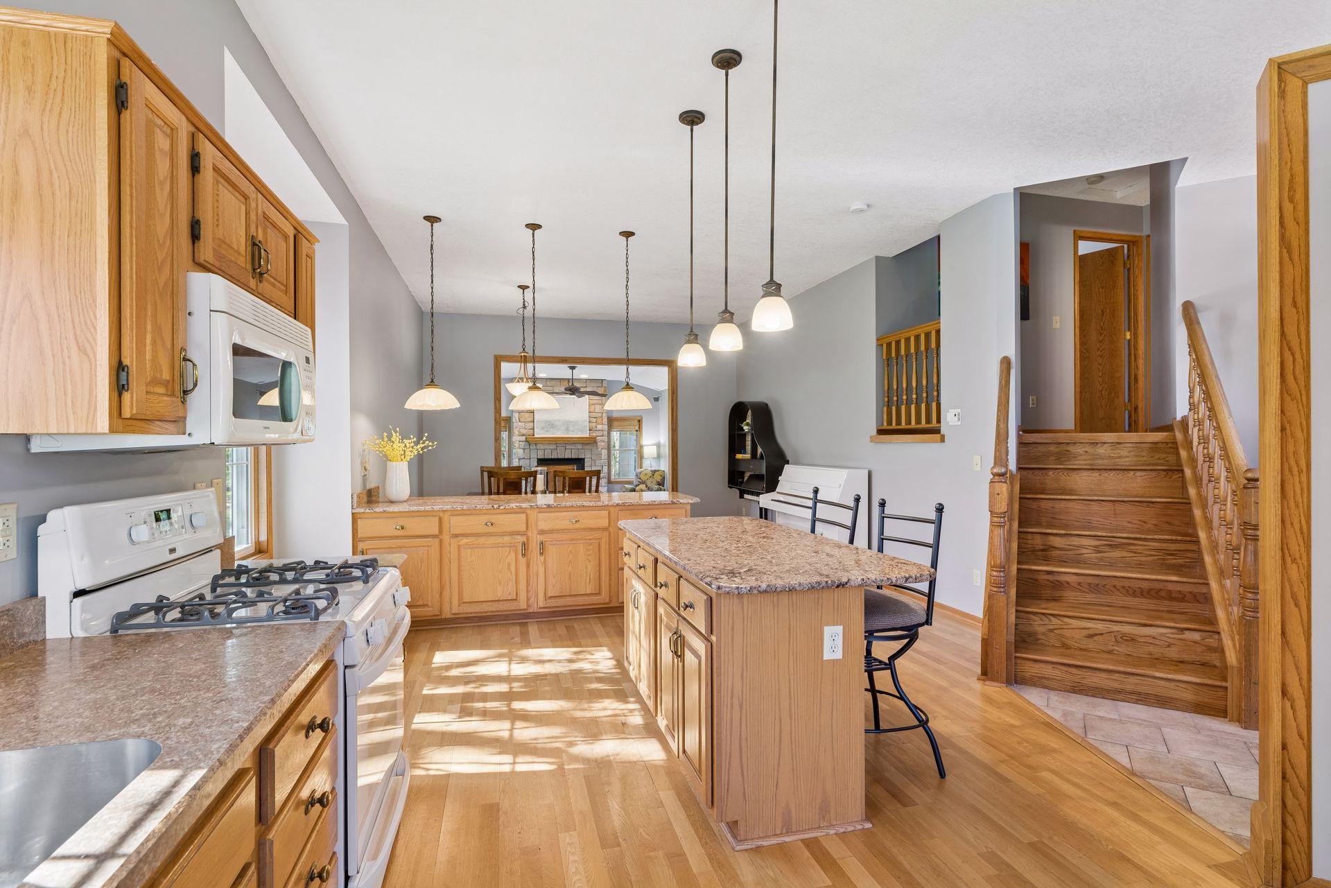 Kitchen boasts a granite topped center island and peninsula, offering tons of storage.