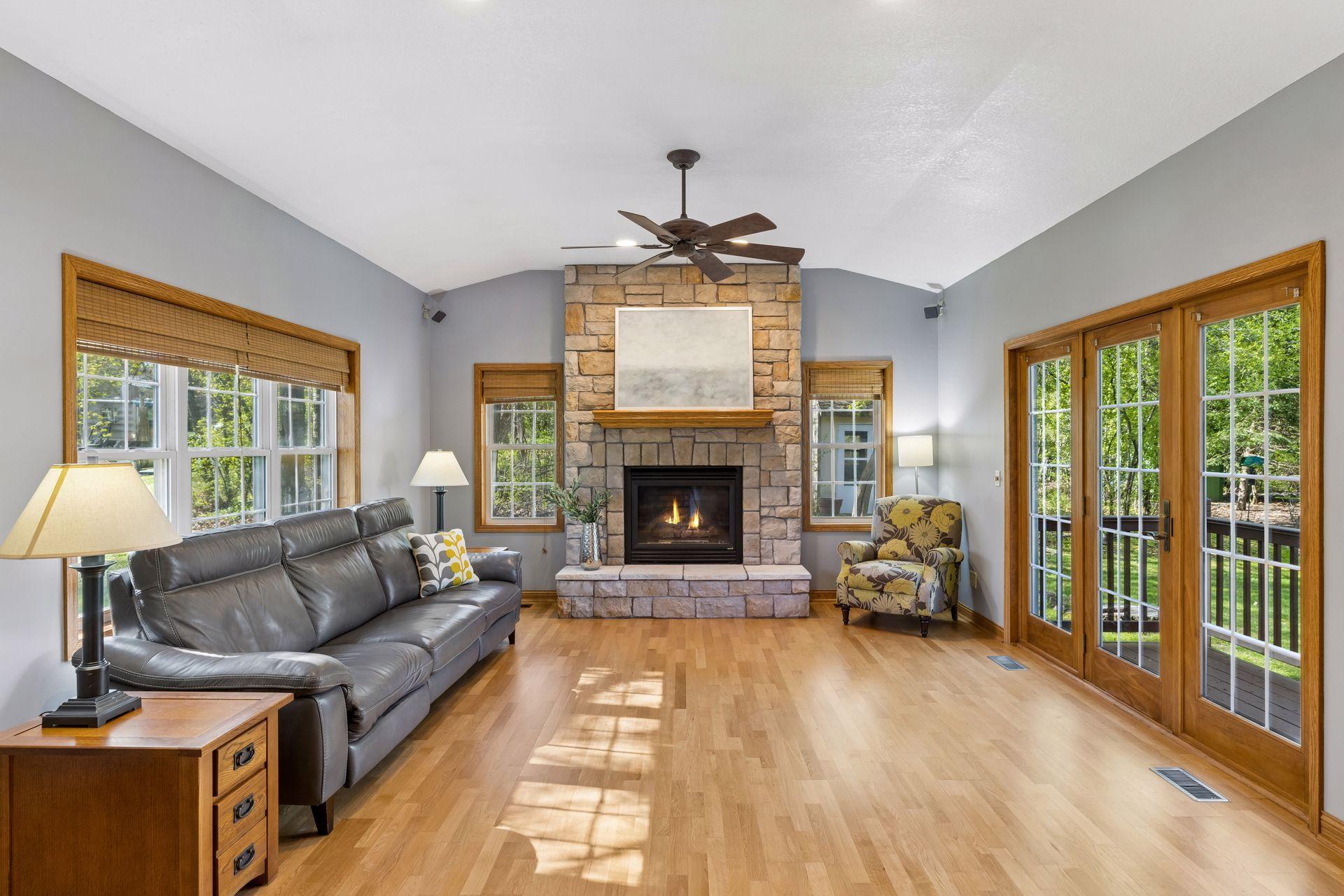 Beautiful living room includes a gas burning fireplace and walls of windows.