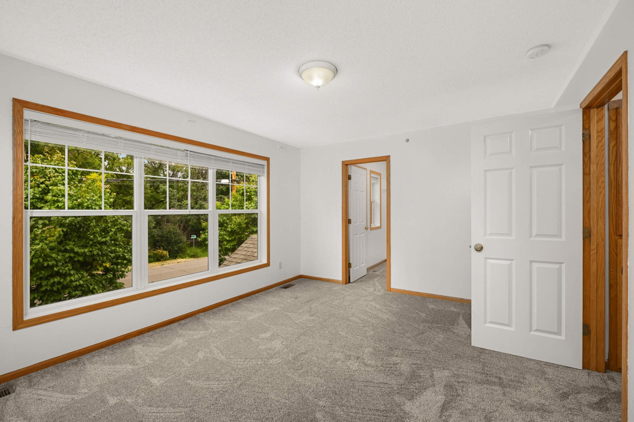 Primary bedroom with large windows and great natural light
