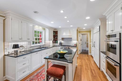 Stunning open kitchen with kitchen island, tile backsplash, and ample cabinet space
